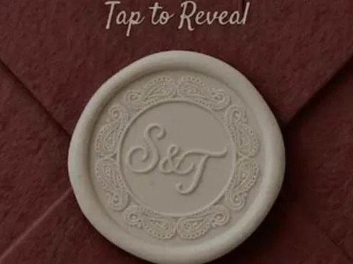 A maroon embossed envelope closed with a wax seal